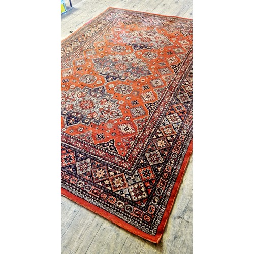 269 - Rectangular red patterned woollen rug approx. 290cm x 200cm