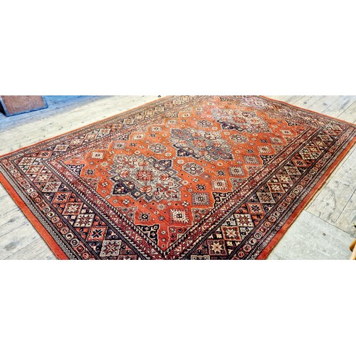 269 - Rectangular red patterned woollen rug approx. 290cm x 200cm