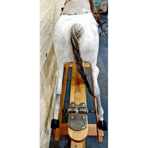 268A - A Tom Cobley dappled grey Rocking Horse on pine stand complete with stirrups and tack, plaited tail ... 