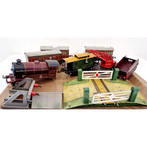 253 - Qty of tin plate O gauge model railway, a damaged engine, rolling stock, level crossing etc