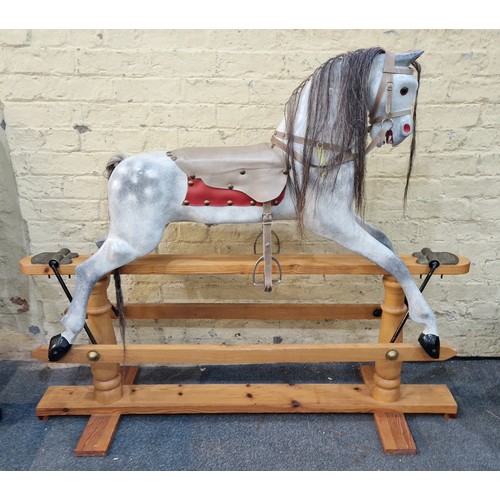 268A - A Tom Cobley dappled grey Rocking Horse on pine stand complete with stirrups and tack, plaited tail ... 