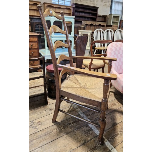 216 - Oak ladder back elbow chair with strung seat and turned stretcher