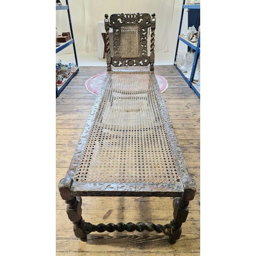 221 - Early 20th century oak ornately carved day bed with barley twist stretchers and rattan panels, some ... 