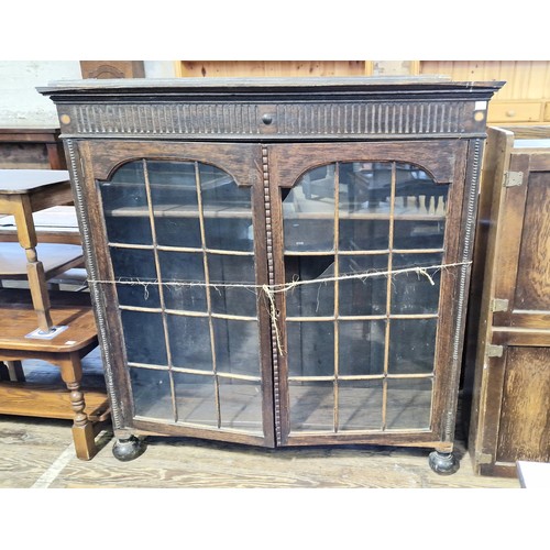 255 - Early 20th century oak glazed bookcase, some  damage