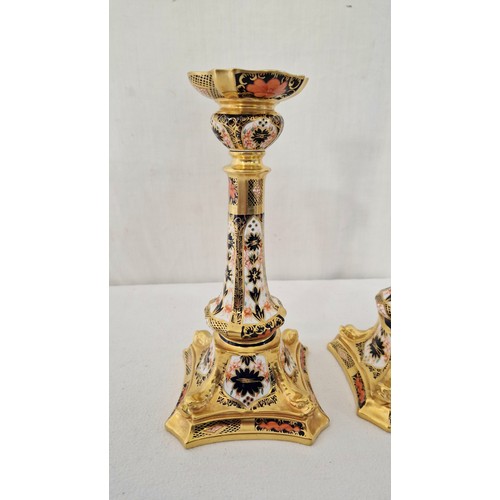 30 - A pair of Royal Crown Derby Imari candlesticks on serpentine square bases c. 27cm tall (hairline cra... 