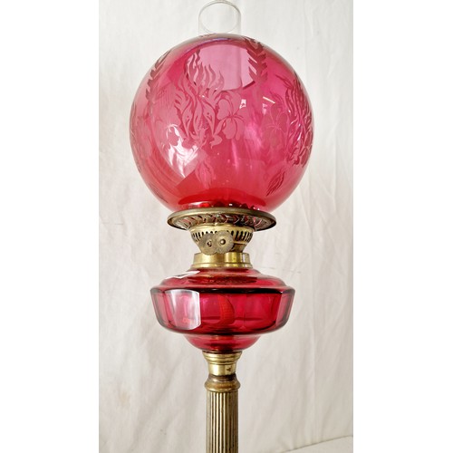 115 - Late Victorian oil lamp with cranberry glass reservoir and shade