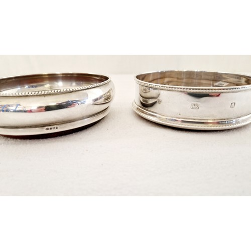 154 - Two silver wine coasters, Birmingham 1972 with beaded rim and London 1994 with beaded rim and base