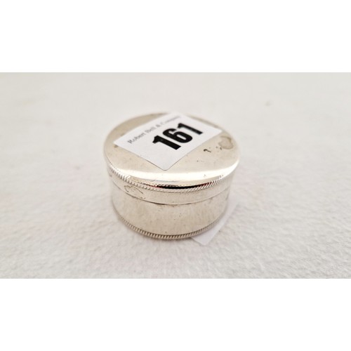161 - A Sheffield 1917 silver cylindrical pill box with engine turned rim and base c. 0.8 ozs