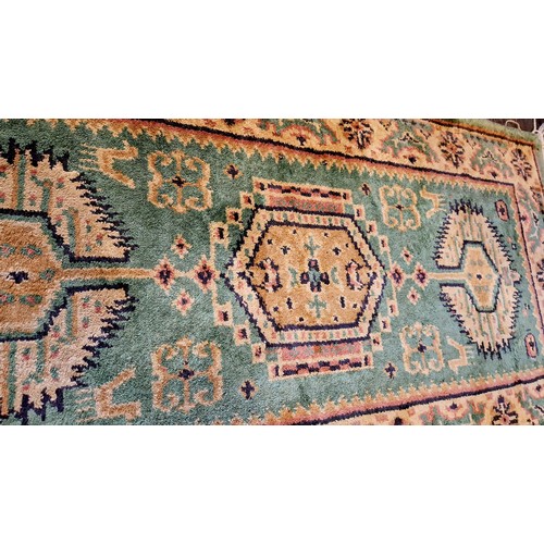 200 - Patterned green woollen rug approx. 123cm x 62cm