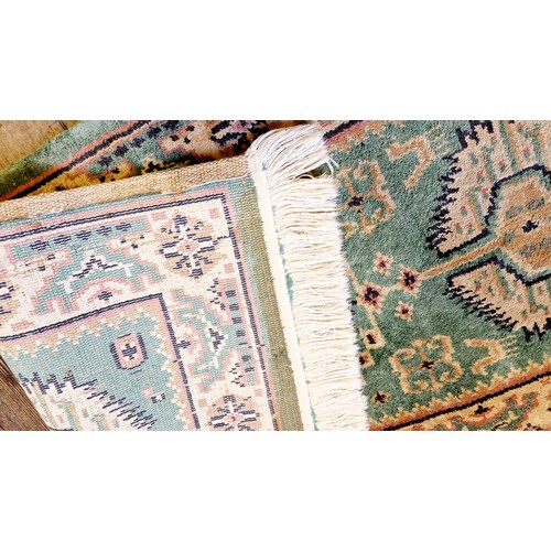 200 - Patterned green woollen rug approx. 123cm x 62cm