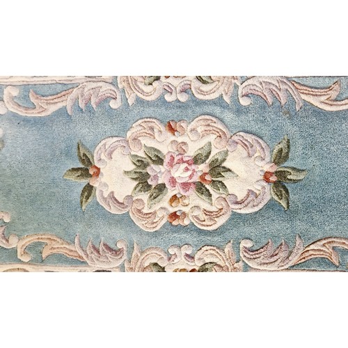 201 - Two rectangular woollen floral rugs approx. 123cm x 62cm