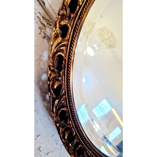 205 - Circular pierced gilt framed wall mirror with bevelled plate