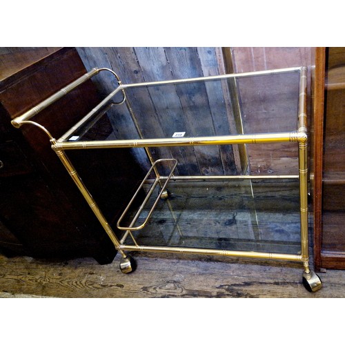 273 - Brass framed and smoked glass 2-tier drinks trolley