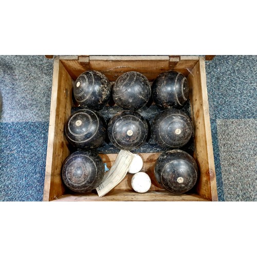 Wooden crate of vintage lawn bowls and two Taylor-Rolph jacks