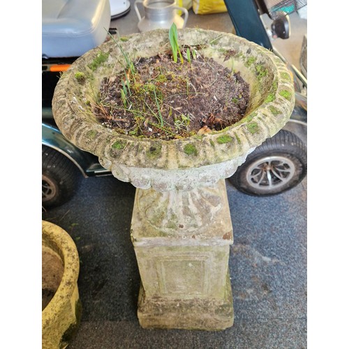 316 - Simulated stone garden pedestal urn on a plinth