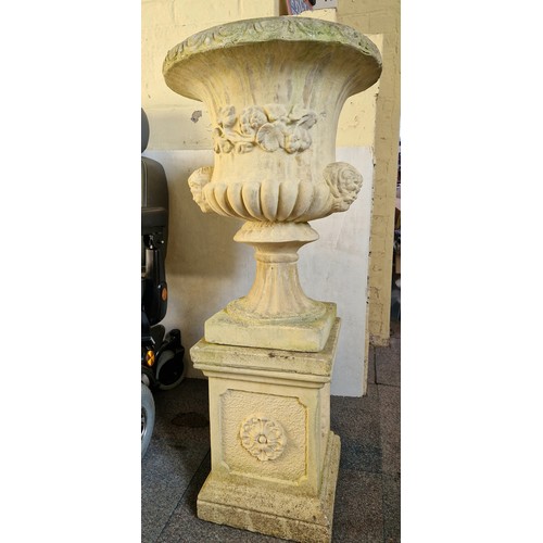 317 - Simulated stone garden pedestal urn with mask detail on plinth approx. 110cm tall