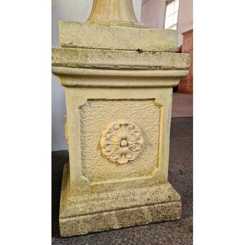 317 - Simulated stone garden pedestal urn with mask detail on plinth approx. 110cm tall