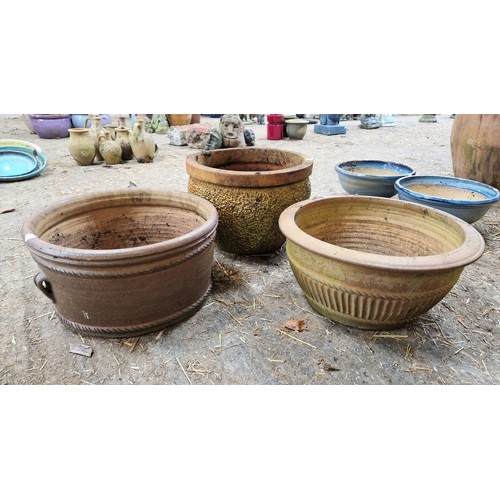 41 - Three glazed terracotta planters and three feet