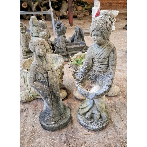 61 - Two simulated stone garden figures and a pair of planters on feet