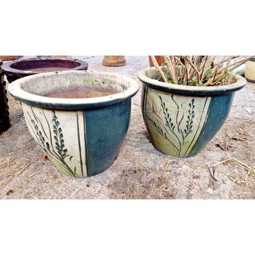 69 - Two pairs of coloured glazed terracotta planters