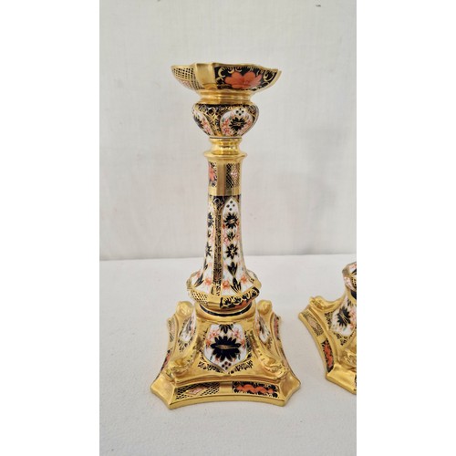 161 - A pair of Royal Crown Derby Imari candlesticks on serpentine square bases c. 27cm tall (hairline cra... 