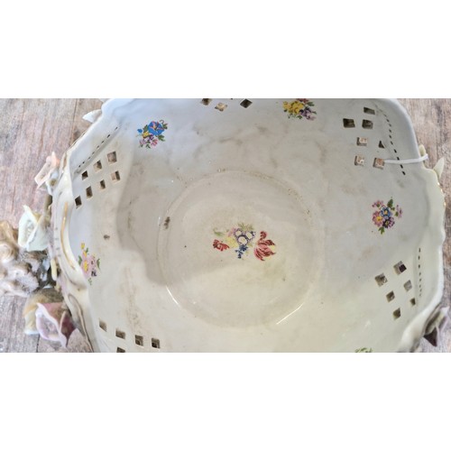 169 - Meissen floral basket on putti support