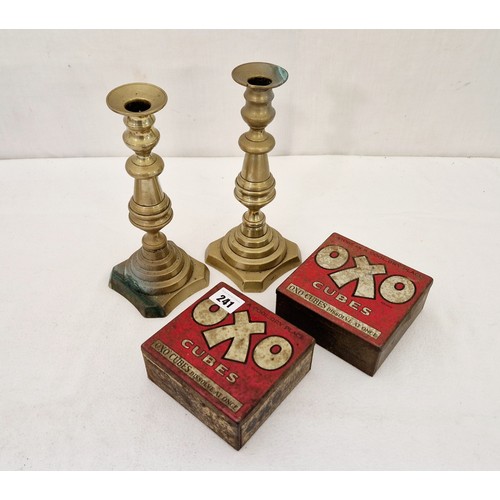 241 - Two vintage OXO tins and a pair of Victorian candlesticks