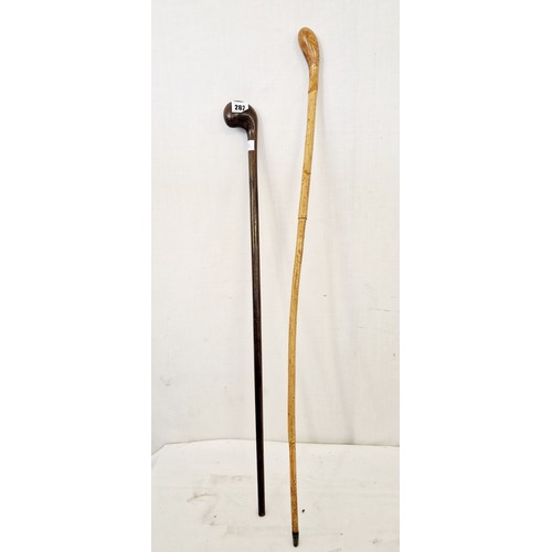 262 - Two carved wooden walking sticks