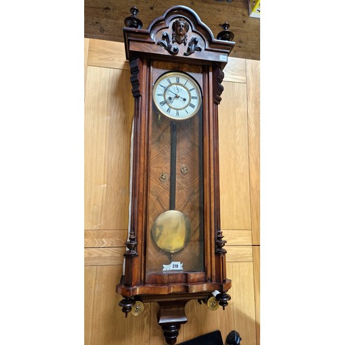 279 - Walnut and mahogany cased Vienna wall clock with mask faced finials