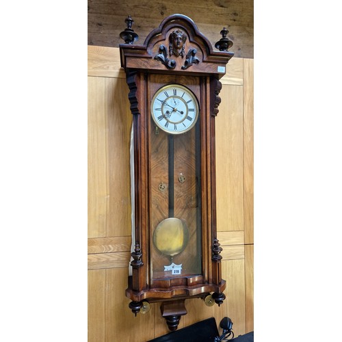 279 - Walnut and mahogany cased Vienna wall clock with mask faced finials