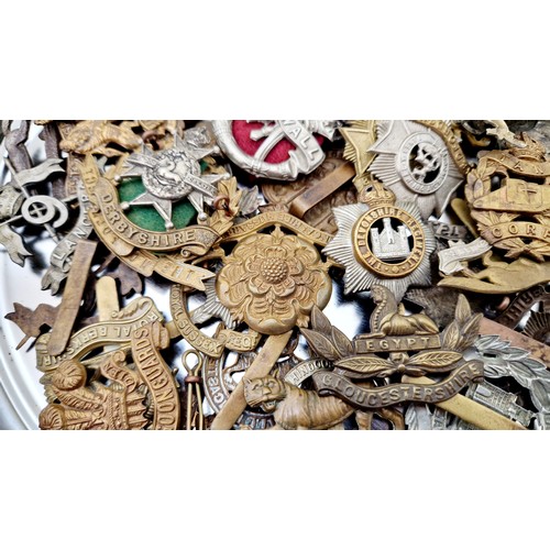 293 - A quantity of various British regimented cap badges