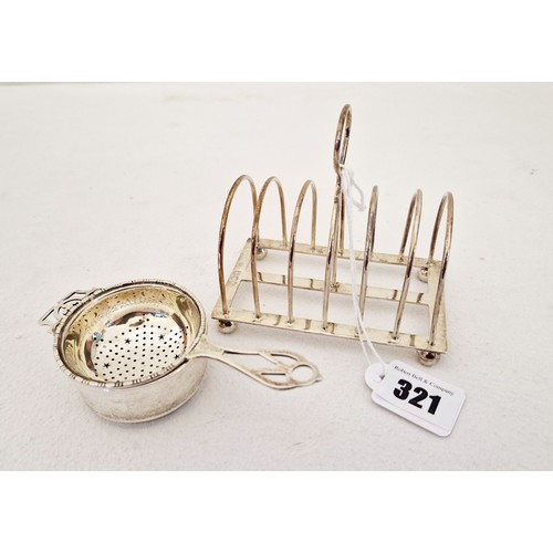 321 - Two pieces of silver tableware, a London 1897six slat wire toast rack and Birmingham 1931 tea strain... 