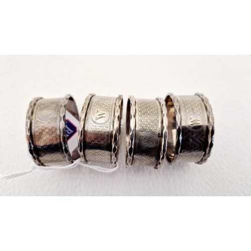 326 - A set of four Birmingham 1939 silver napkin rings with engine turned decoration monogrammed W (one d... 