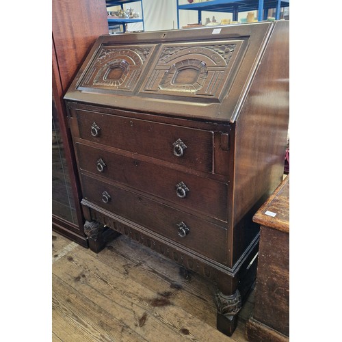 436 - Mid century oak bureau with relief fall front to a base of three drawers