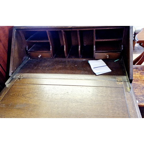 436 - Mid century oak bureau with relief fall front to a base of three drawers