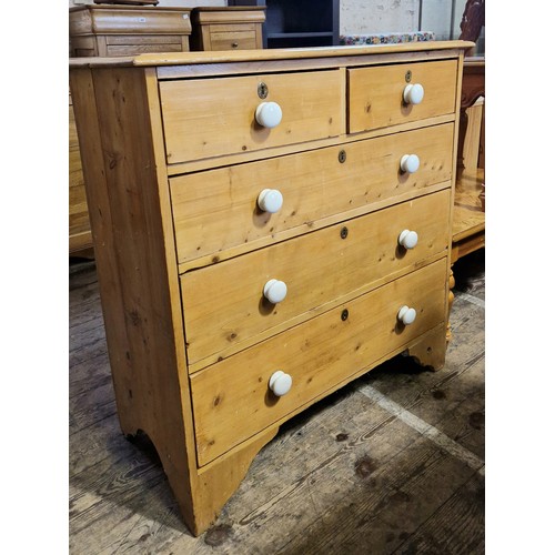 442 - Early 20th century pine straight front chest of two over three drawers with ceramic bun handles