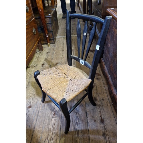 450 - Childs ebonised chair with rush seat