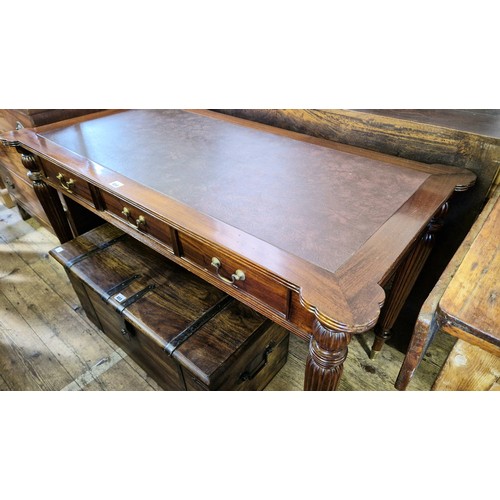 454 - Reproduction mahogany rectangular writing table with leatherette insert, three frieze drawers on tap... 