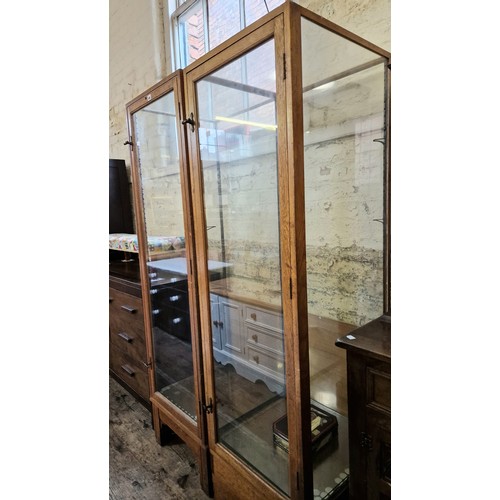 475 - Two mid century elm framed upright square retail/collector's display cabinets, with steel lever turn... 