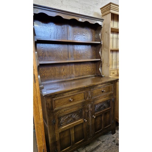 476 - Modern oak dresser with three-tier plate rack over a base of two drawers and cupboards