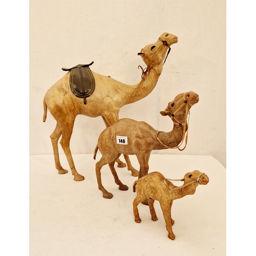 146 - Set of three hide camel figurines