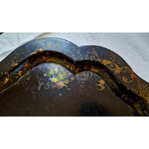 175 - Large lacquered papier-mâché tray with gilt and floral border, damage repaired