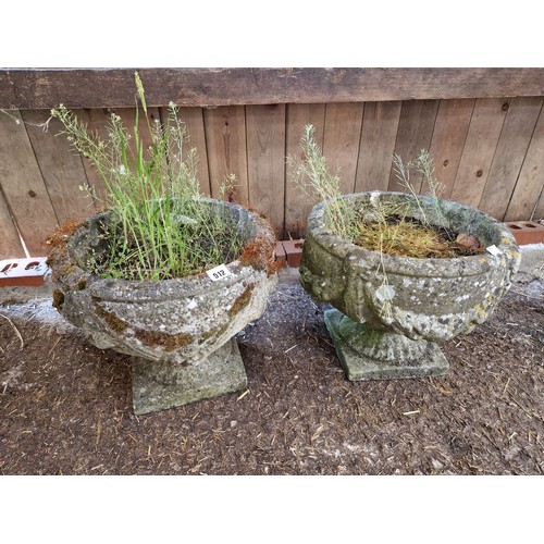 512 - Pair of simulated stone pedestal garden urns with swag detail