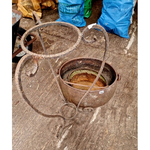 534 - Two cast iron cauldrons and wrought stand