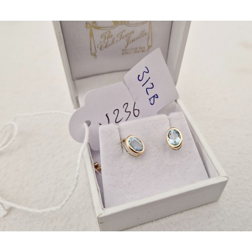 312 - Three pairs of 9ct gold earrings; blue topaz, cubic zirconia studs and drop