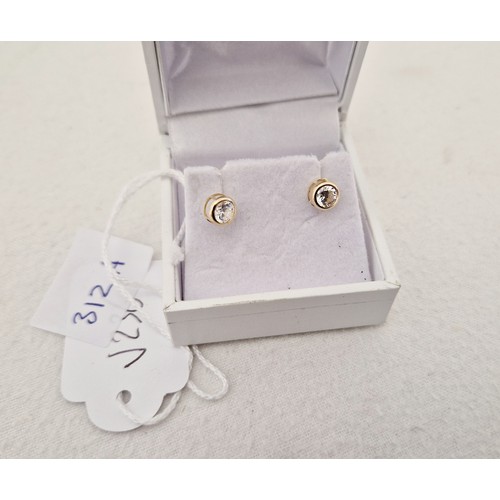 312 - Three pairs of 9ct gold earrings; blue topaz, cubic zirconia studs and drop