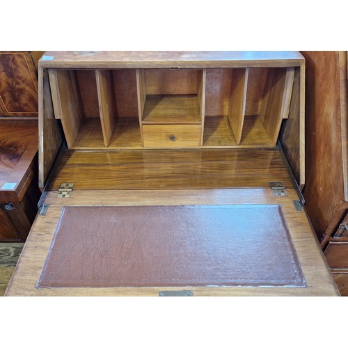 447 - Early 20th century walnut bureau, the fall front enclosing a fitted interior over stepped base of 2 ... 