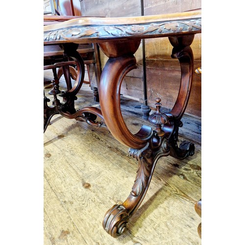 462 - Victorian serpentine walnut centre table with shaped foliate border on carved scrolling legs and pie... 