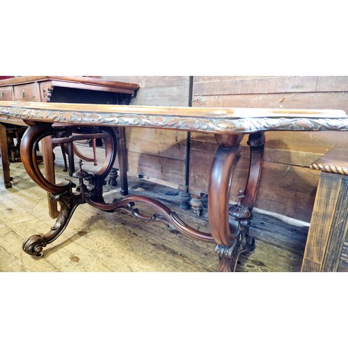 462 - Victorian serpentine walnut centre table with shaped foliate border on carved scrolling legs and pie... 