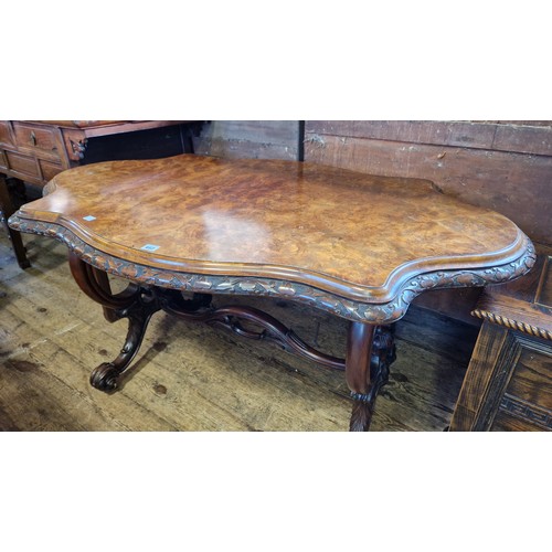 462 - Victorian serpentine walnut centre table with shaped foliate border on carved scrolling legs and pie... 